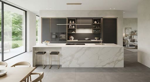Modular kitchen with matte charcoal cabinetry and a quartzite waterfall island